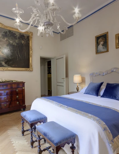 Bed room with double bed in the apartment of Palazzo Larderel in Florence, Tuscany