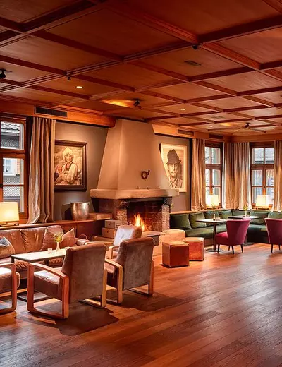 Spacious hall with fireplace and wood panelling at Hotel Hirschen Schwarzenberg, Vorarlberg (c) Photo Adolf Bereuter