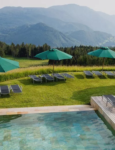 View from the Zirmerhof across the infinity pool, looking out at the beautiful, sunny countryside and the mountains surrounding Radein
