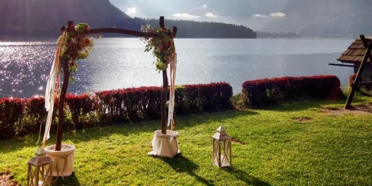 Green meadow on the shores of Lake Hallstatt set up for an outdoor ceremony at Heritage.Hotel Hallstatt in the Salzkammergut