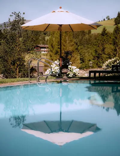 Outdoor pool (c) Schloss Mittersill Outdoor pool with sun umbrella at Schloss Mittersill (c) photo Schloss Mittersill