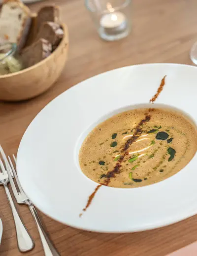 Close-up of an exquisite soup, served on a wooden table at Restaurant Alte Post in Müllheim (c) photo Hotel Alte Post
