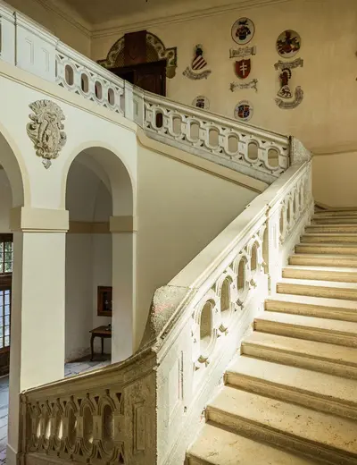 Staircase at Burg Bernstein (c) Matthias Kronfuss Magnificent staircase with coats of arms adorning the walls at Burg Bernstein (c) photo Matthias Kronfuss