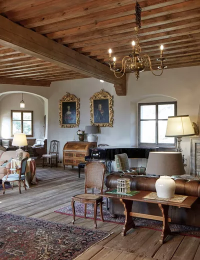 Elegantly furnished salon with antique furniture and wooden ceiling at Schloss Englar in Eppan, South Tyrol